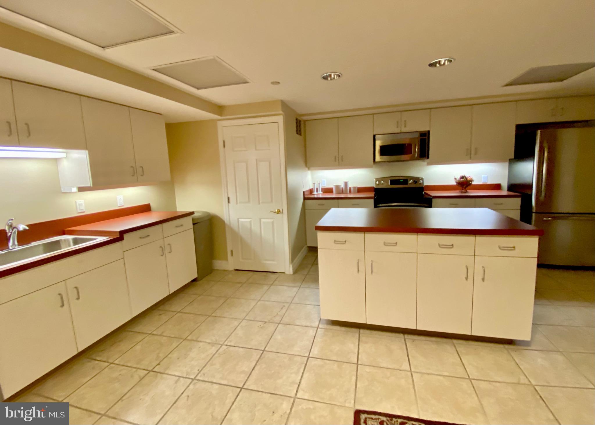 1600-18 Arch Street, Unit 803 Philadelphia, PA 19103 - Photo 27 of 34 a kitchen with stainless steel appliances a sink cabinets and a counter top space