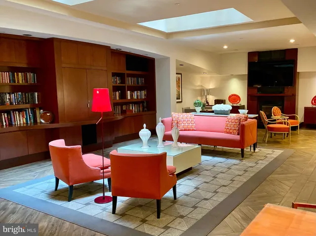 a bedroom with furniture and a book shelf