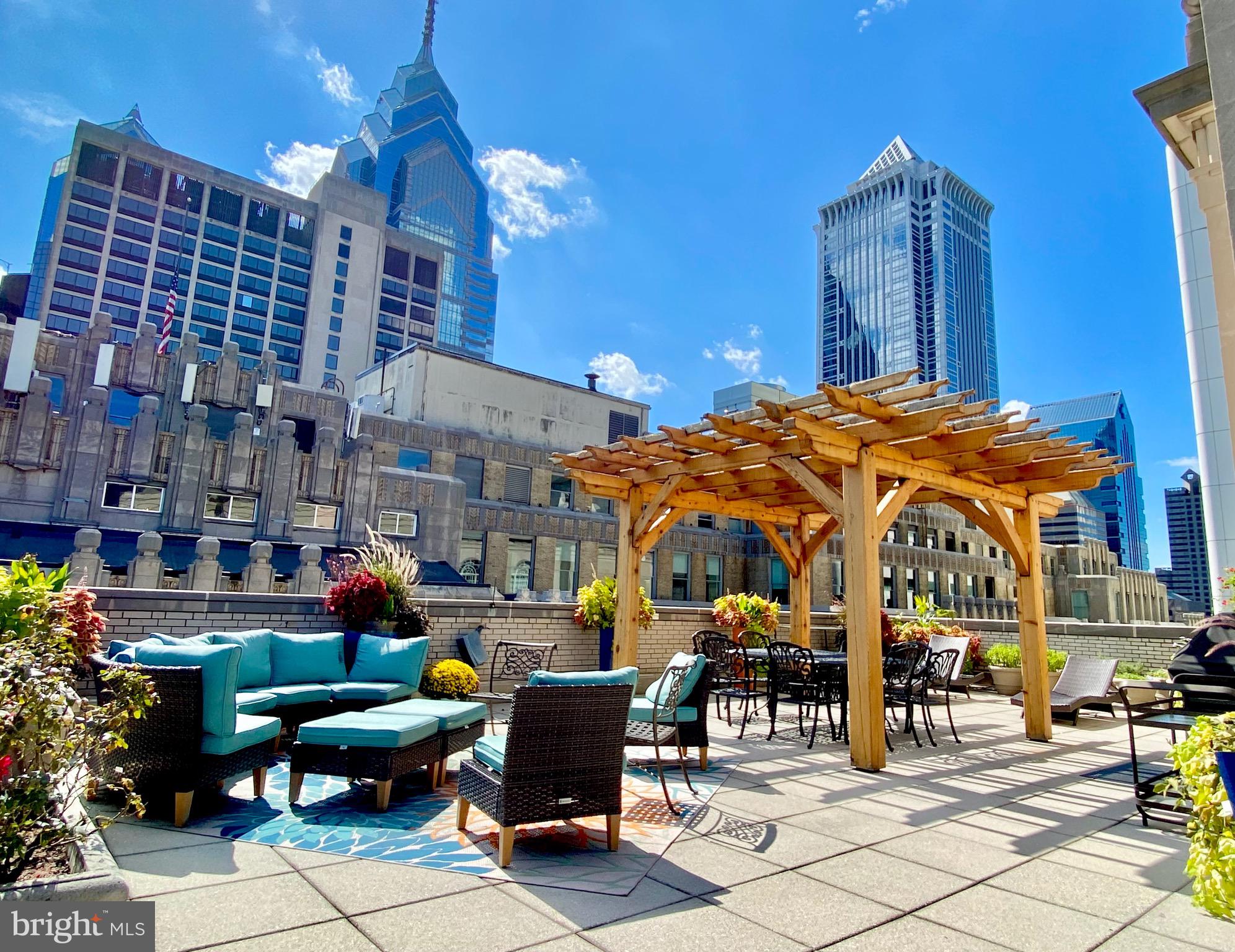 1600-18 Arch Street, Unit 803 Philadelphia, PA 19103 - Photo 30 of 34 a view of a patio with dining table and chairs