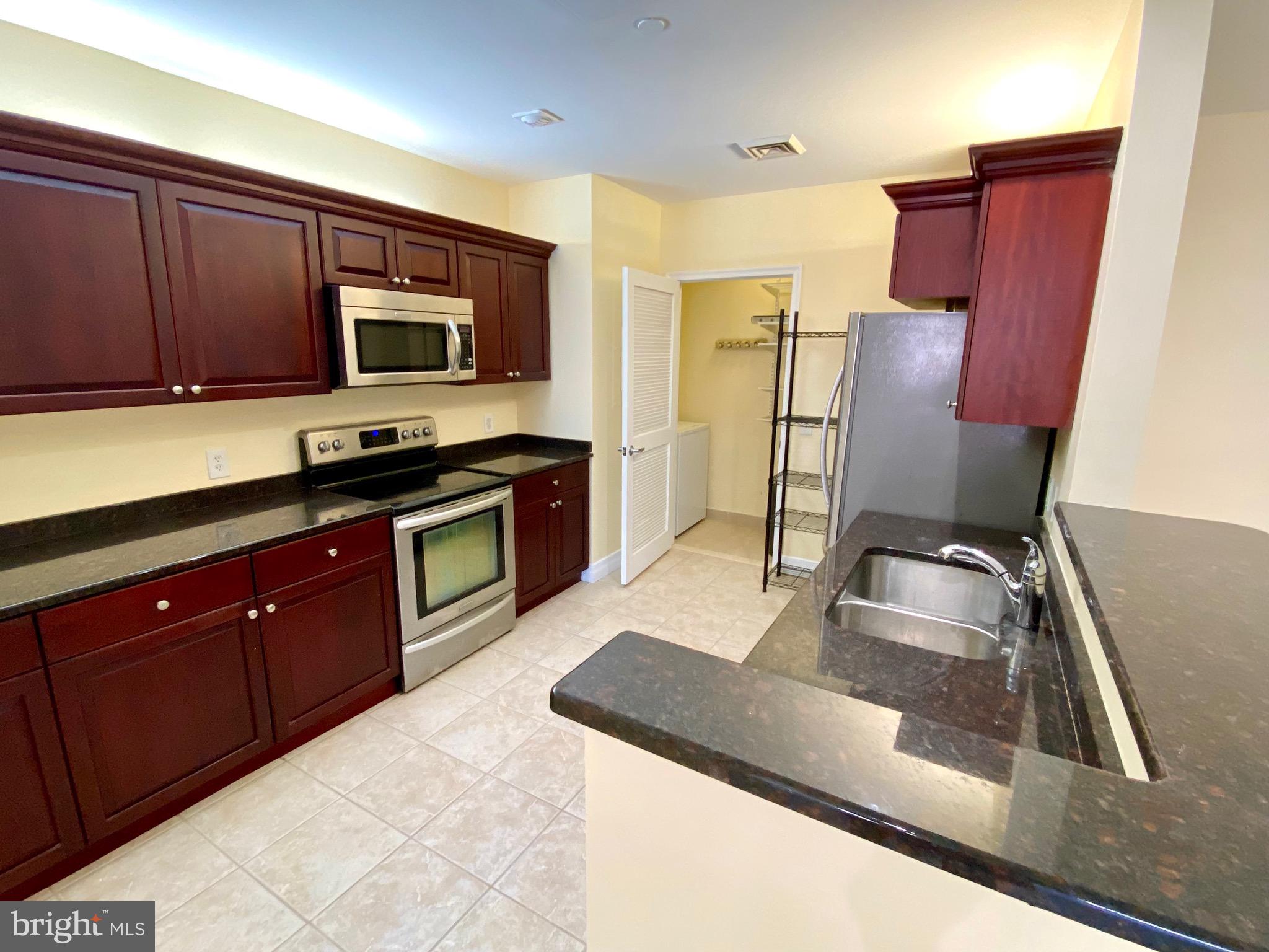 1600-18 Arch Street, Unit 803 Philadelphia, PA 19103 - Photo 6 of 34 a kitchen with stainless steel appliances granite countertop a sink stove and refrigerator