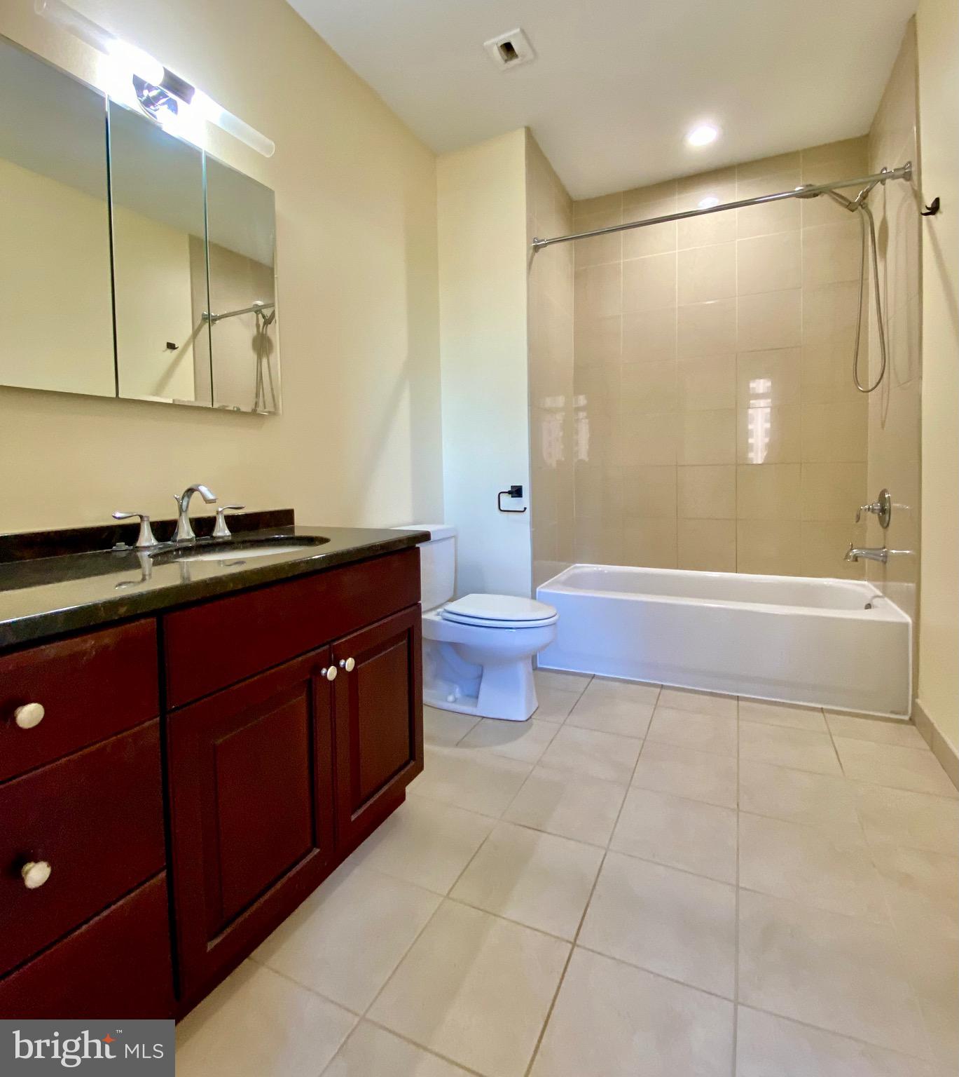 1600-18 Arch Street, Unit 803 Philadelphia, PA 19103 - Photo 9 of 34 a bathroom with a double vanity sink toilet mirror and bathtub