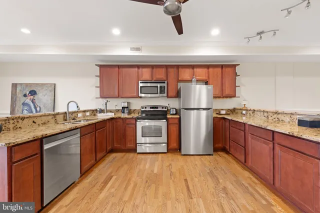 a kitchen with stainless steel appliances granite countertop a stove and a sink