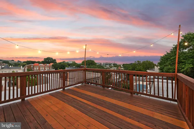 a balcony with wooden floor and fence