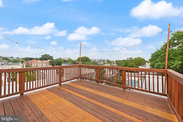a balcony with wooden floor in city view