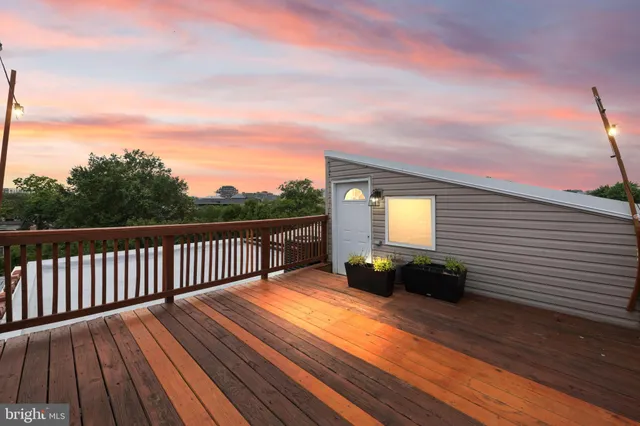 a bedroom with a large bed and a wooden floor
