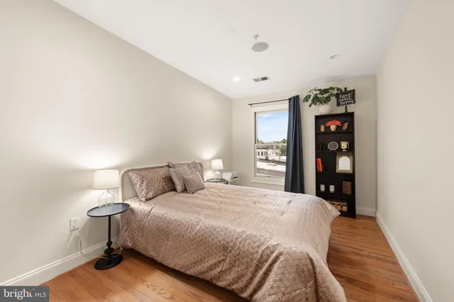 a spacious bedroom with a bed and a window