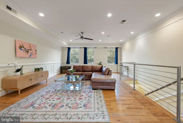 a living room with furniture and kitchen view