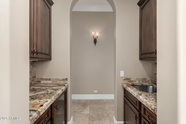 a kitchen with granite countertop a stove and a sink