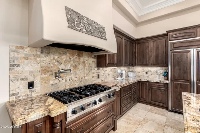 a kitchen with a stove a sink and a refrigerator