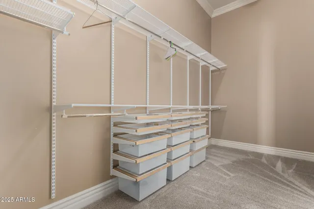 a large bed sitting in a bedroom next to a bathroom