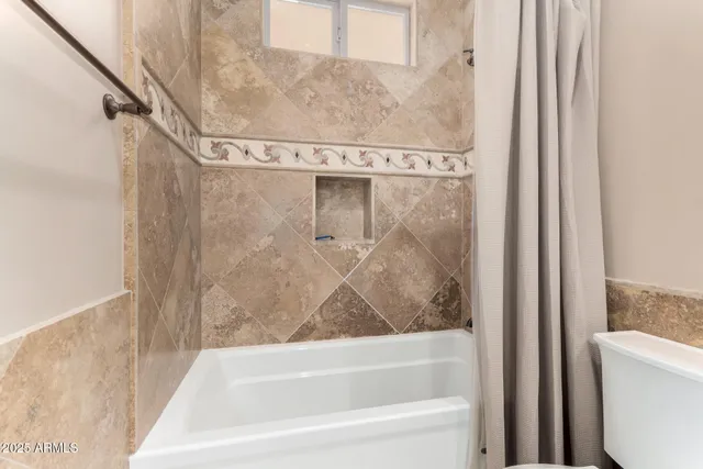 a large bed sitting in a bedroom next to a bathroom