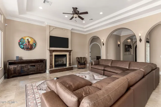 a living room with furniture a flat screen tv and a fireplace