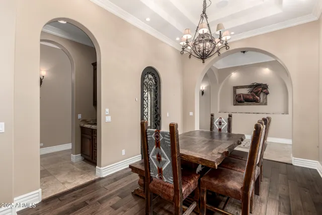 a view of a dining room with furniture and chandelier
