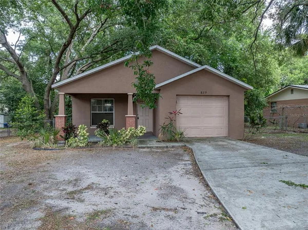 a view of a house with a yard and garage