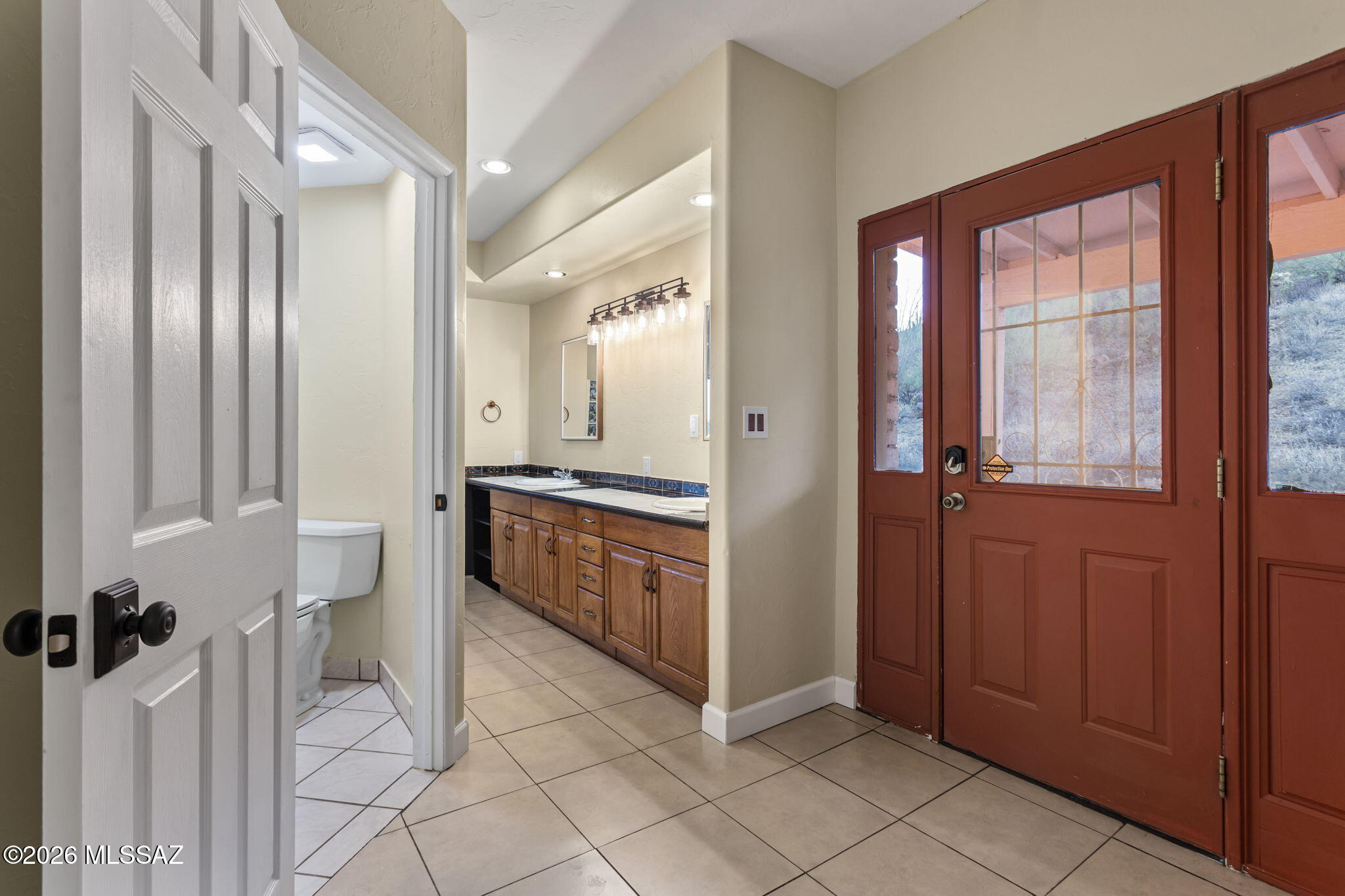 4210 West Mossman Road Tucson, AZ 85746 - Photo 22 of 51 a bathroom with a double vanity sink and a mirror