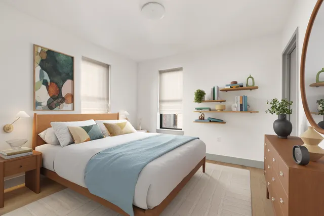 a bedroom with a bed and a large mirror