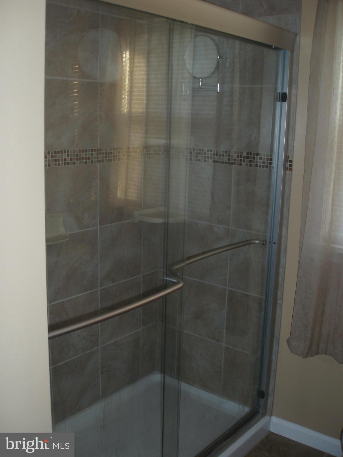 1417 Barrett Road Baltimore, MD 21207 - Photo 12 of 18 a bathroom with a glass shower door
