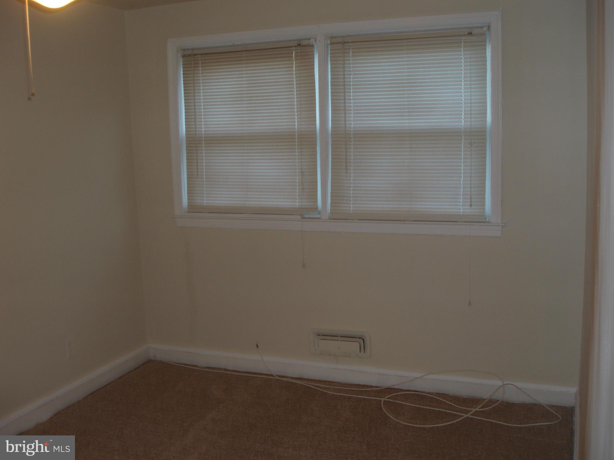 1417 Barrett Road Baltimore, MD 21207 - Photo 9 of 18 an empty room with a bench