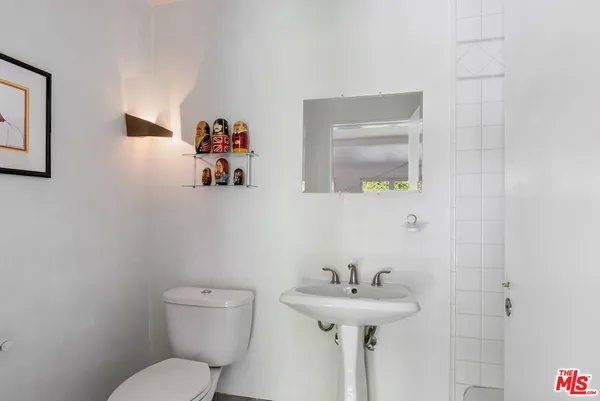 a bathroom with a white shower and window