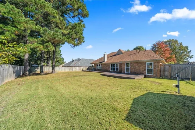 a house view with swimming pool in front of it