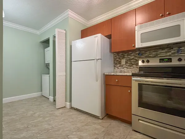 a kitchen with a stove and a refrigerator