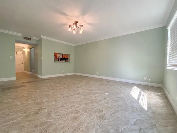 a view of an empty room with a window
