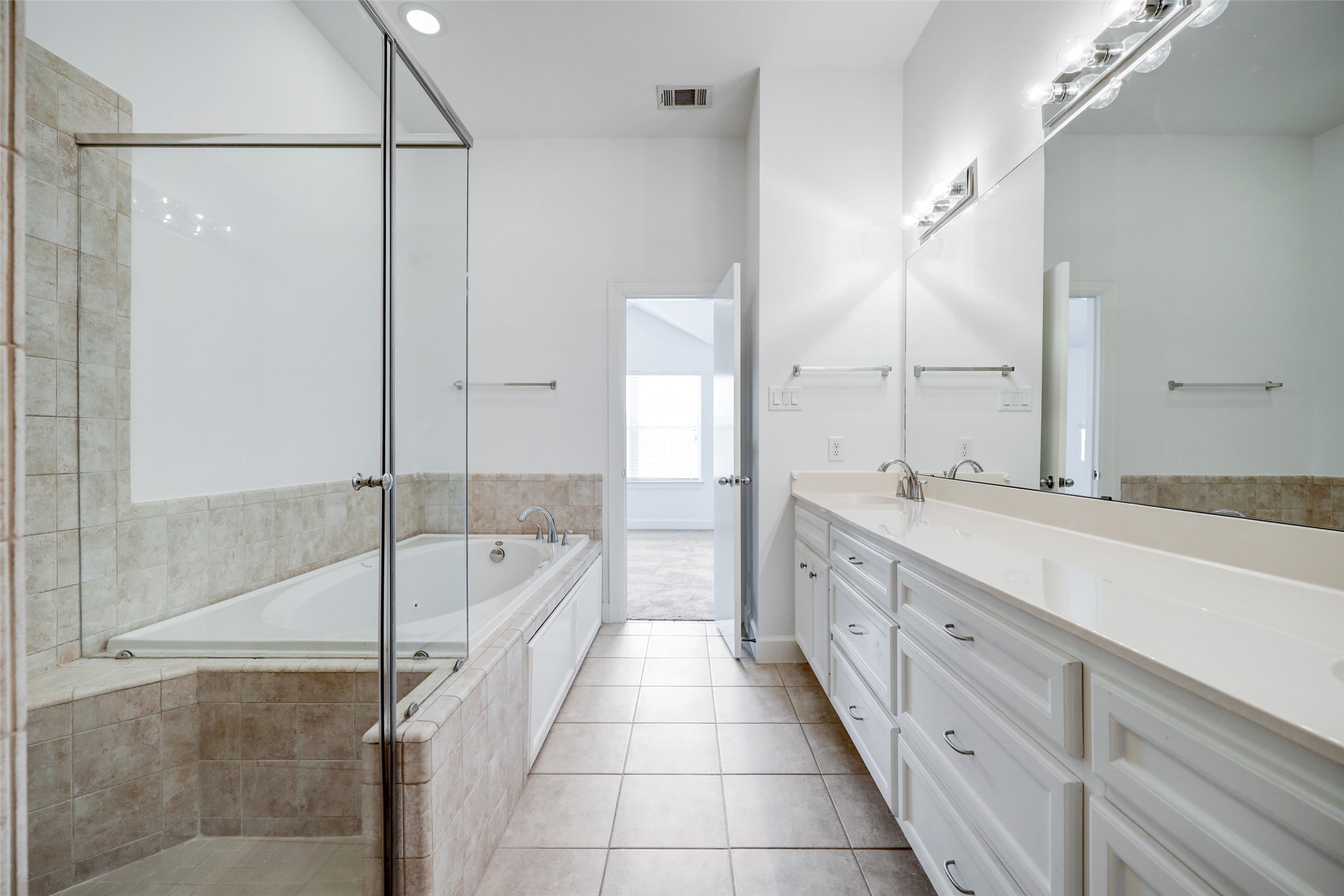 5941 South Loop E Freeway, Unit 1002 Houston, TX 77033 - Photo 14 of 16 a bathroom with a granite countertop sink a mirror and a bathtub