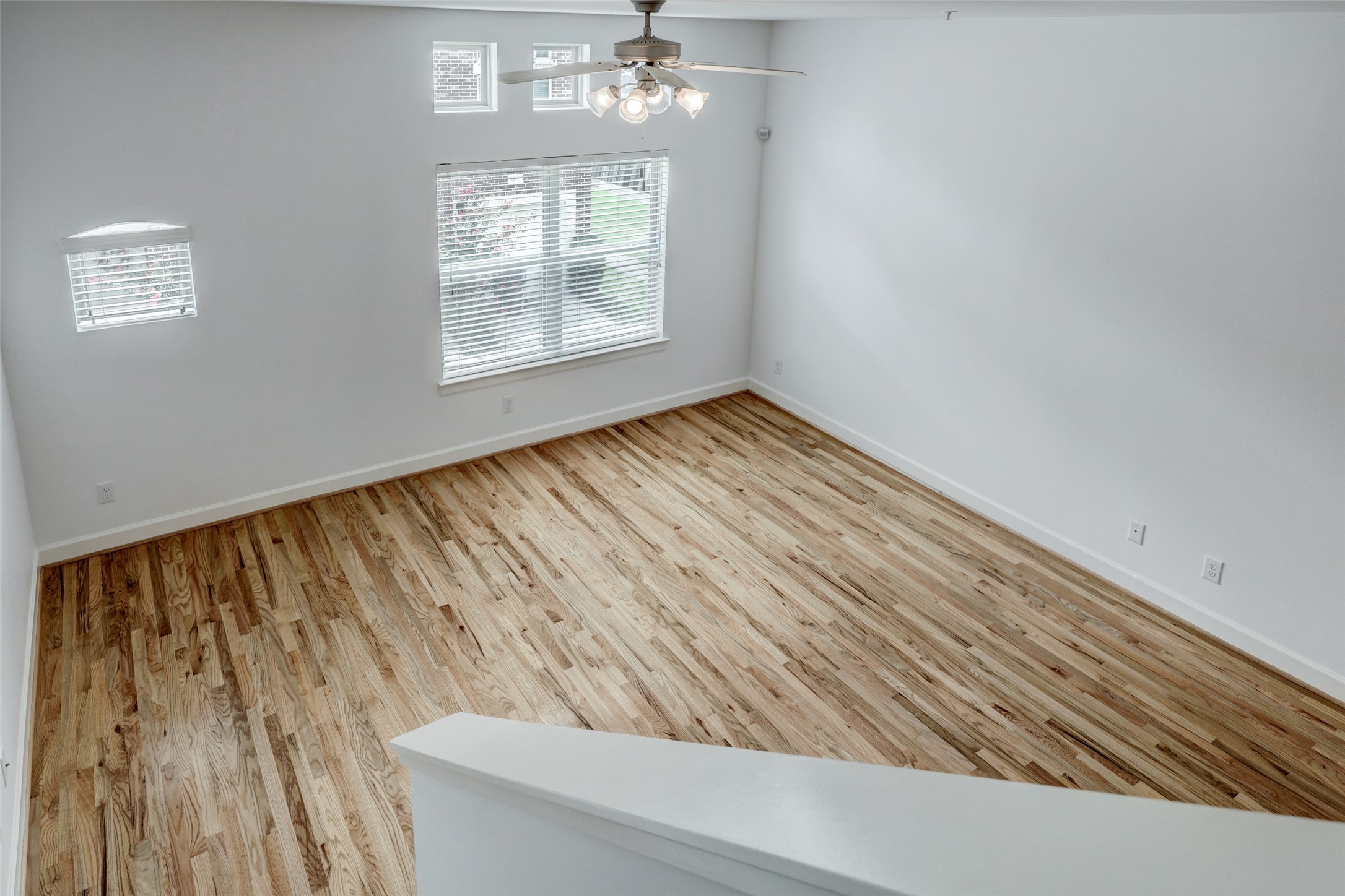 5941 South Loop E Freeway, Unit 1002 Houston, TX 77033 - Photo 3 of 16 a view of an empty room with wooden floor and a window