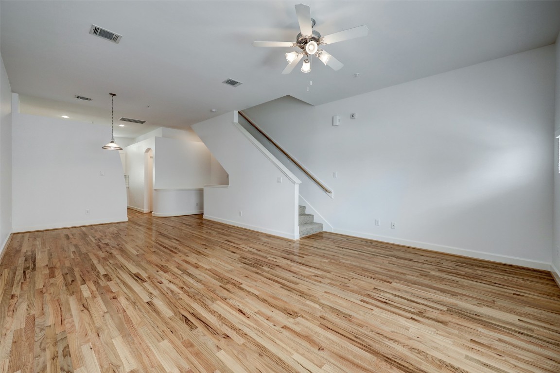 5941 South Loop E Freeway, Unit 1002 Houston, TX 77033 - Photo 4 of 16 a view of empty room with wooden floor and fan