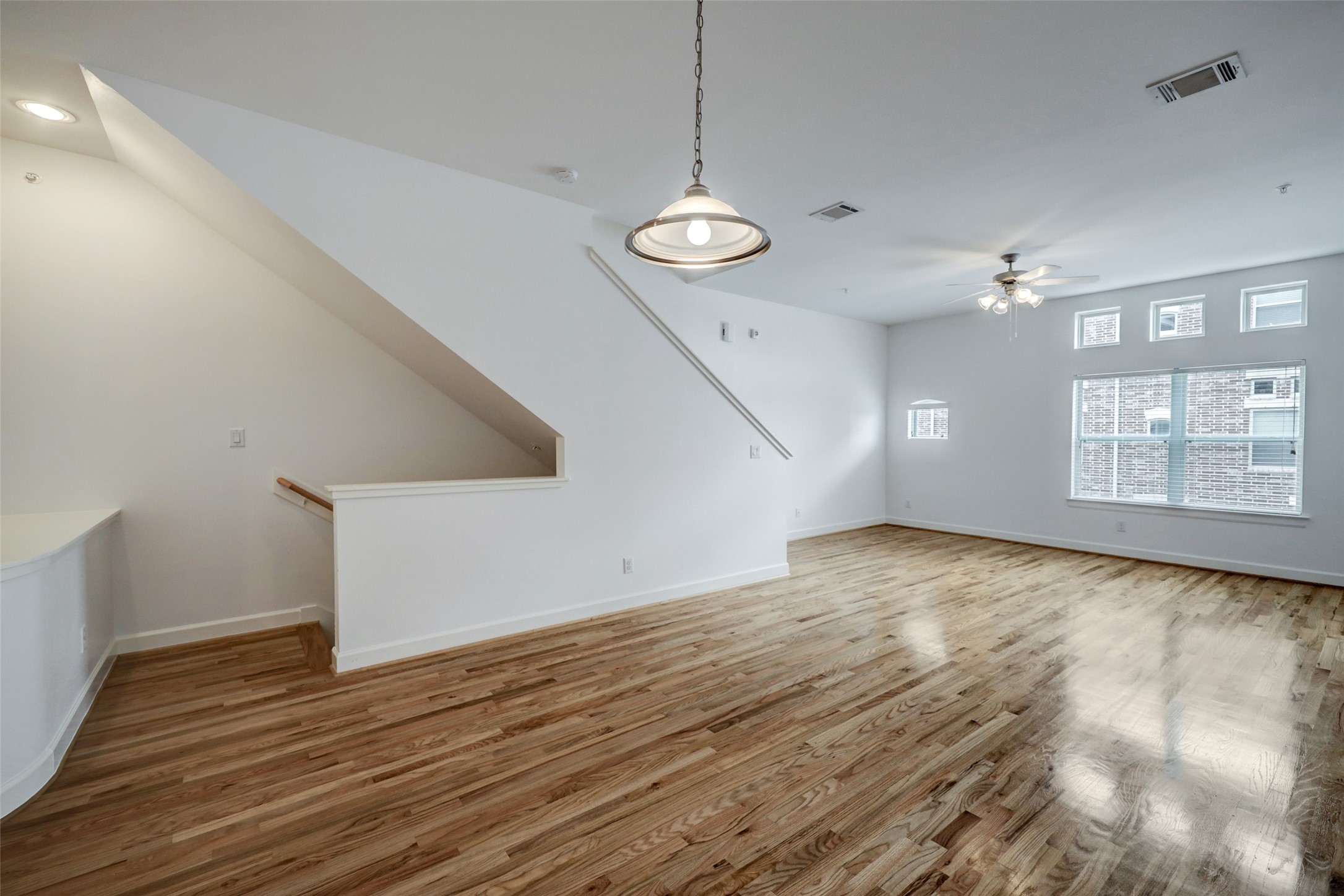 5941 South Loop E Freeway, Unit 1002 Houston, TX 77033 - Photo 5 of 16 a view of an empty room with wooden floor and a window