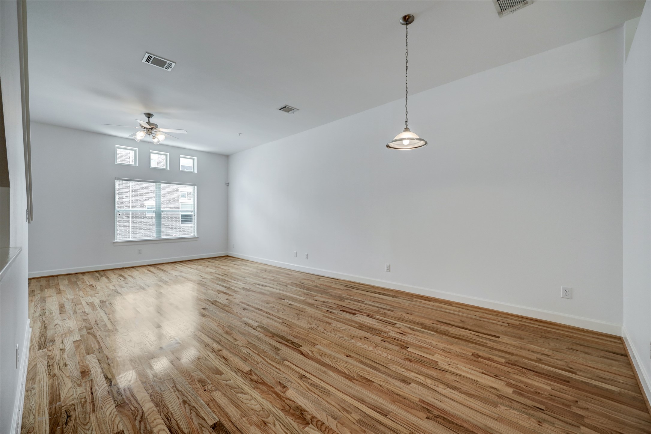 5941 South Loop E Freeway, Unit 1002 Houston, TX 77033 - Photo 6 of 16 a view of a room with wooden floor and fan