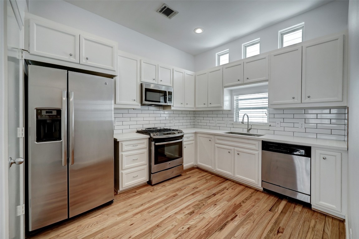 5941 South Loop E Freeway, Unit 1002 Houston, TX 77033 - Photo 8 of 16 a kitchen with granite countertop white cabinets and stainless steel appliances