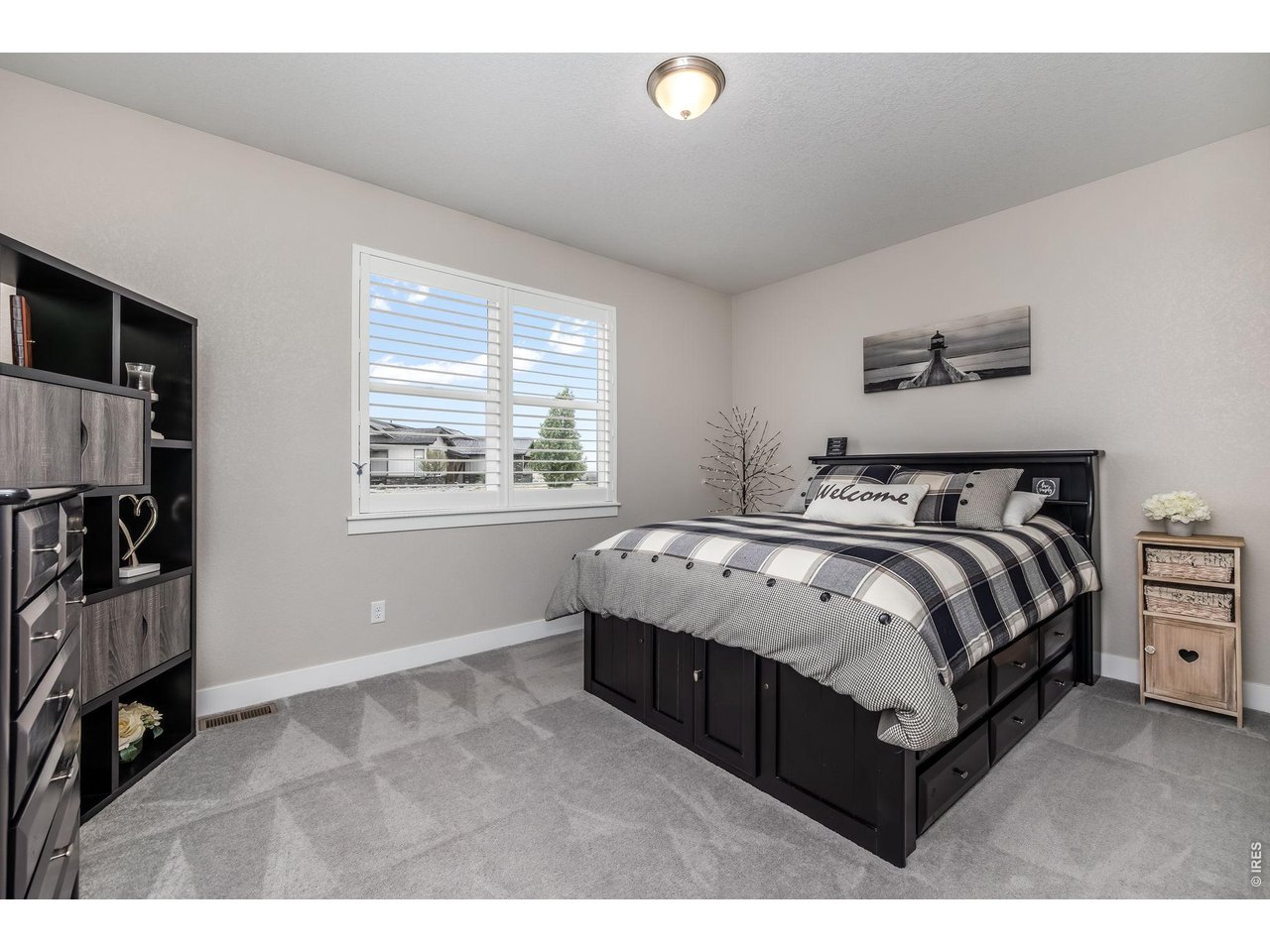3789 Bridle Ridge Circle Severance, CO 80524 - Photo 29 of 44 a spacious bedroom with a bed and a window