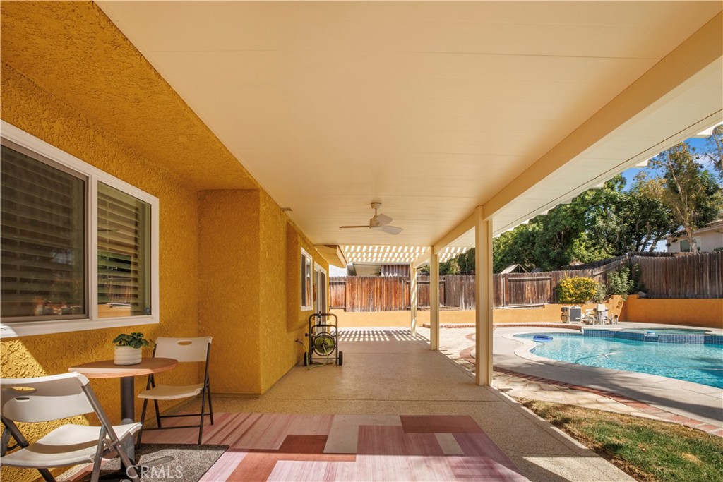 22705 Robin Way Grand Terrace, CA 92313 - Photo 14 of 15 a view of a patio with a table and chairs and couches with wooden floor