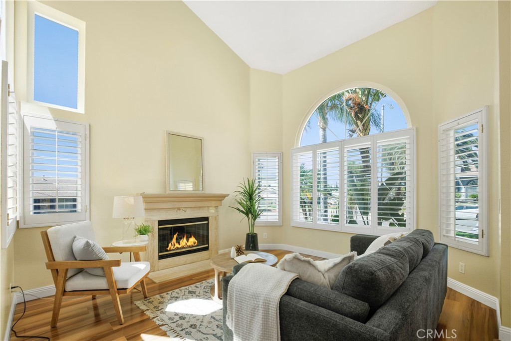 22705 Robin Way Grand Terrace, CA 92313 - Photo 2 of 15 a living room with furniture a large window and a fireplace