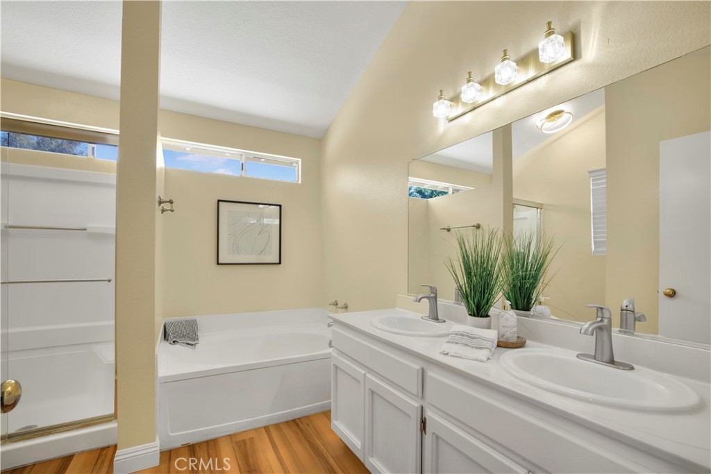22705 Robin Way Grand Terrace, CA 92313 - Photo 10 of 15 a bathroom with a granite countertop sink vanity and mirror