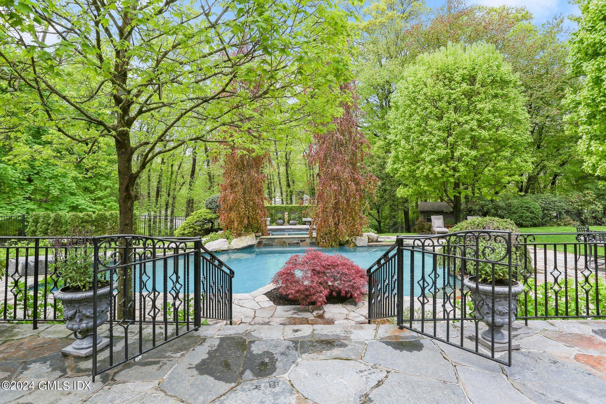 376 Westover Road Stamford, CT 06902 - Photo 32 of 37 a view of a two chairs and table in the back yard of the house