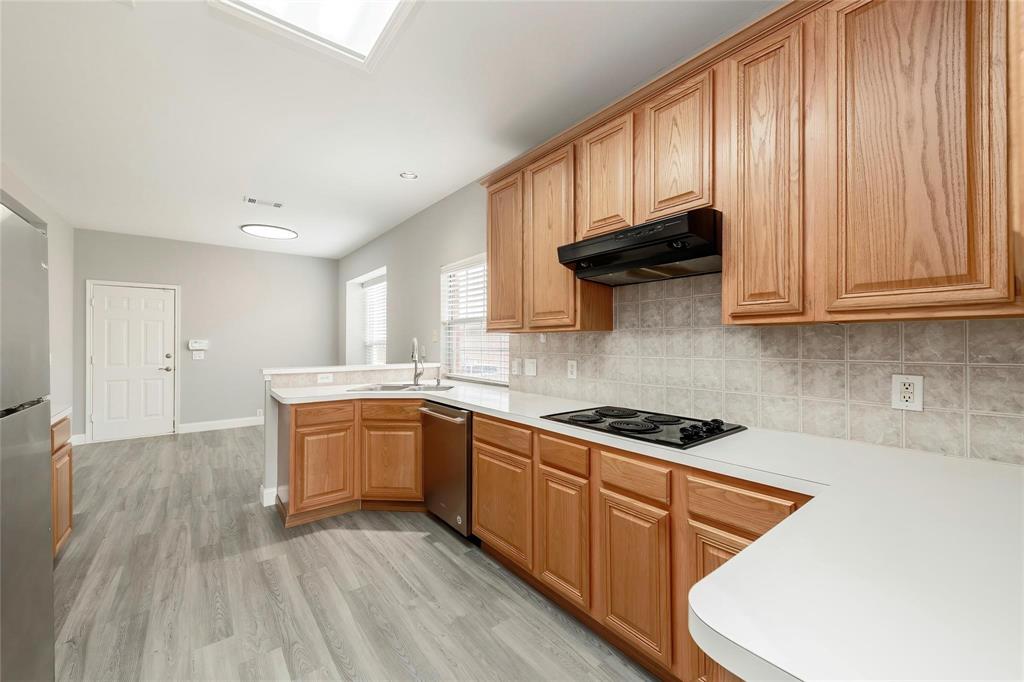 2313 Hunters Run Drive Plano, TX 75025 - Photo 12 of 36 a kitchen with stainless steel appliances granite countertop a stove a sink and a microwave