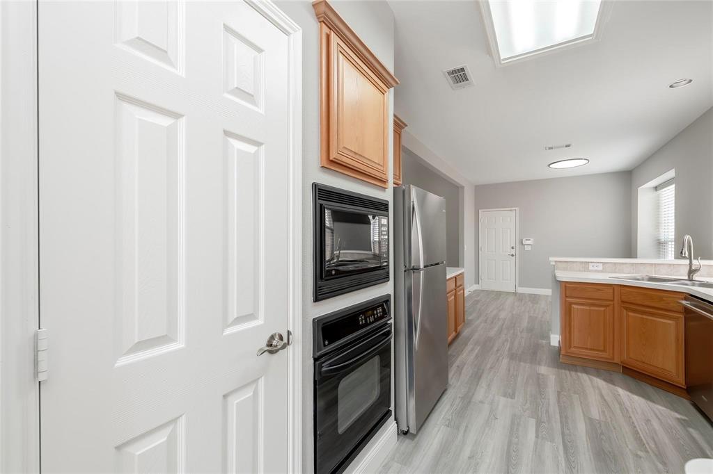 2313 Hunters Run Drive Plano, TX 75025 - Photo 13 of 36 a kitchen with stainless steel appliances granite countertop a refrigerator and a sink