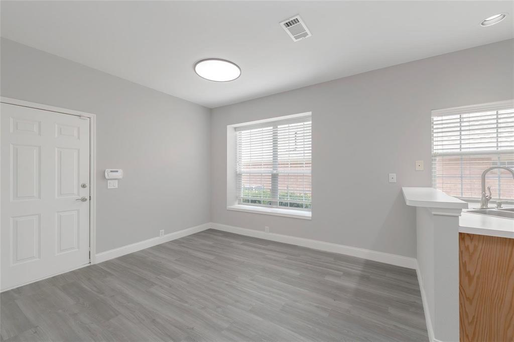 2313 Hunters Run Drive Plano, TX 75025 - Photo 14 of 36 an empty room with wooden floor and windows