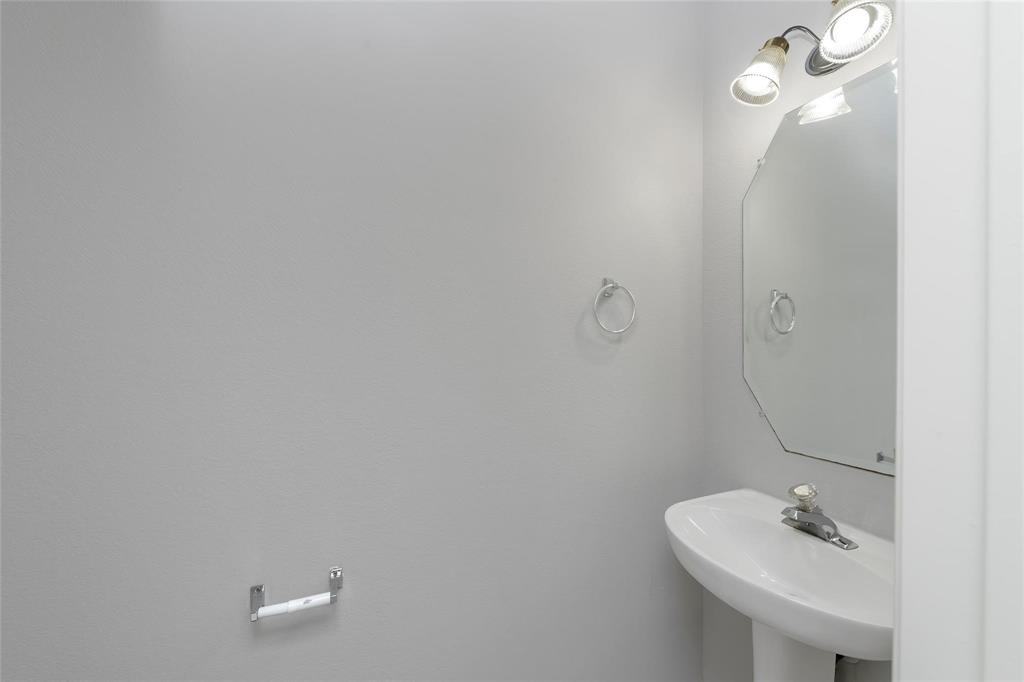 2313 Hunters Run Drive Plano, TX 75025 - Photo 15 of 36 a bathroom with a sink a toilet and a mirror