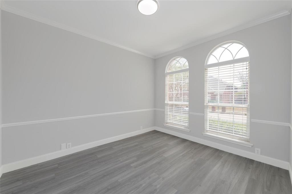 2313 Hunters Run Drive Plano, TX 75025 - Photo 16 of 36 an empty room with wooden floor and windows