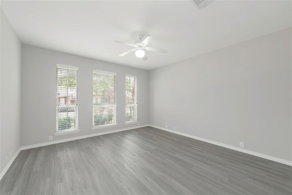 2313 Hunters Run Drive Plano, TX 75025 - Photo 18 of 36 an empty room with wooden floor and windows