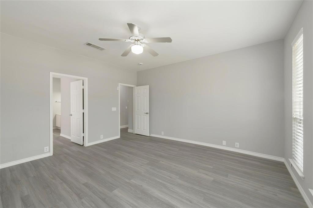2313 Hunters Run Drive Plano, TX 75025 - Photo 19 of 36 an empty room with wooden floor and fan
