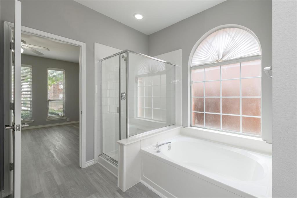 2313 Hunters Run Drive Plano, TX 75025 - Photo 21 of 36 an empty room with wooden floor a ceiling fan and window
