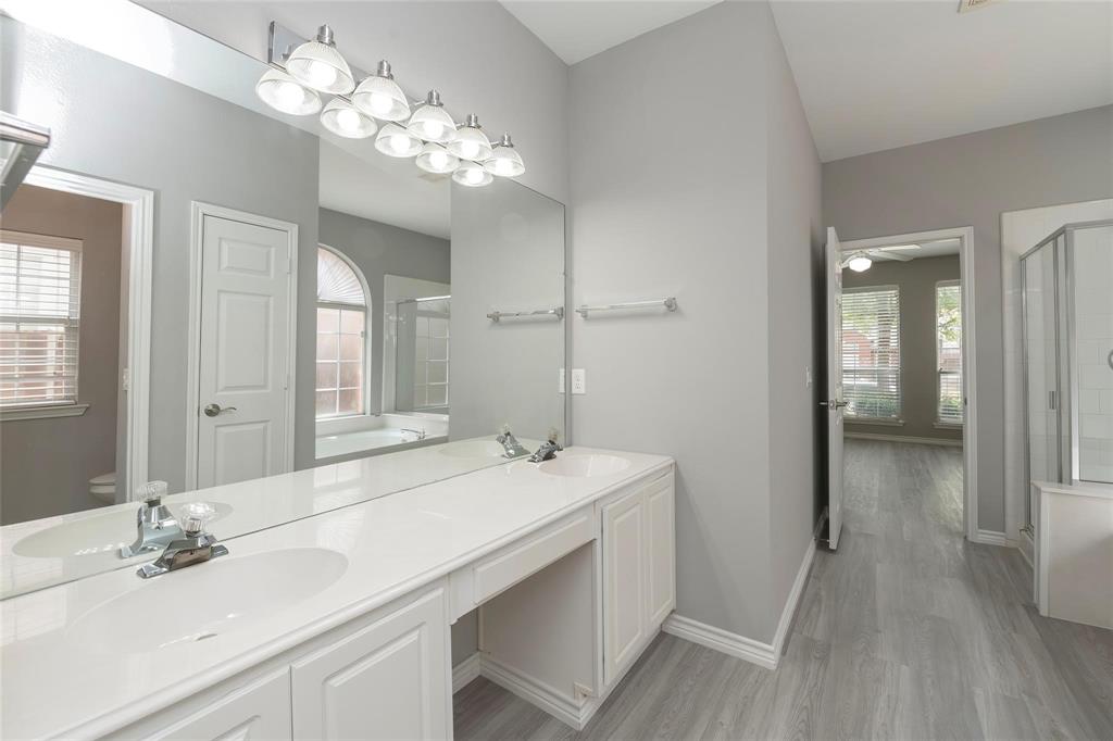 2313 Hunters Run Drive Plano, TX 75025 - Photo 22 of 36 a bathroom with a sink double vanity and a mirror
