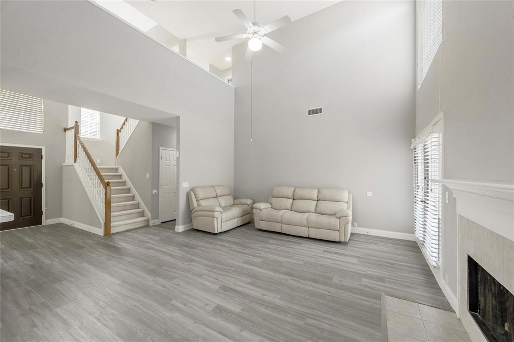 2313 Hunters Run Drive Plano, TX 75025 - Photo 8 of 36 a living room with furniture and a wooden floor