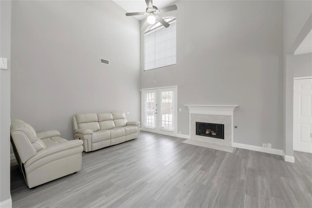 2313 Hunters Run Drive Plano, TX 75025 - Photo 10 of 36 a living room with furniture and a fireplace