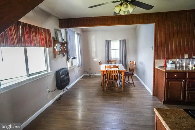 a dining room with furniture and wooden floor