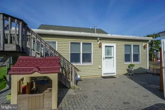 a red brick house with a small yard and a large window